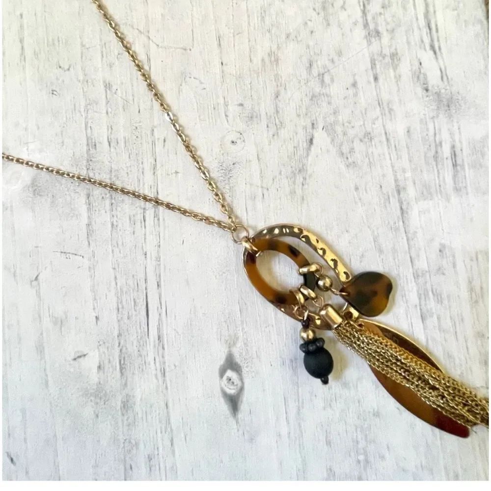Long gold tone  charm tassel necklace